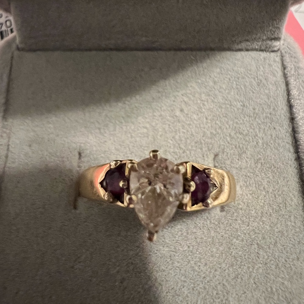 Beautiful 3/4 caret Diamond solitaire with genuine rubies on the side.